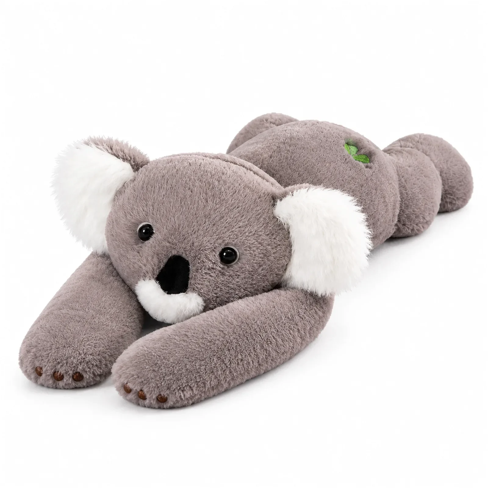 Szara koala leży na brzuchu skosem, długie łapy rozłożone na całą długość, jasne ciepłe tło